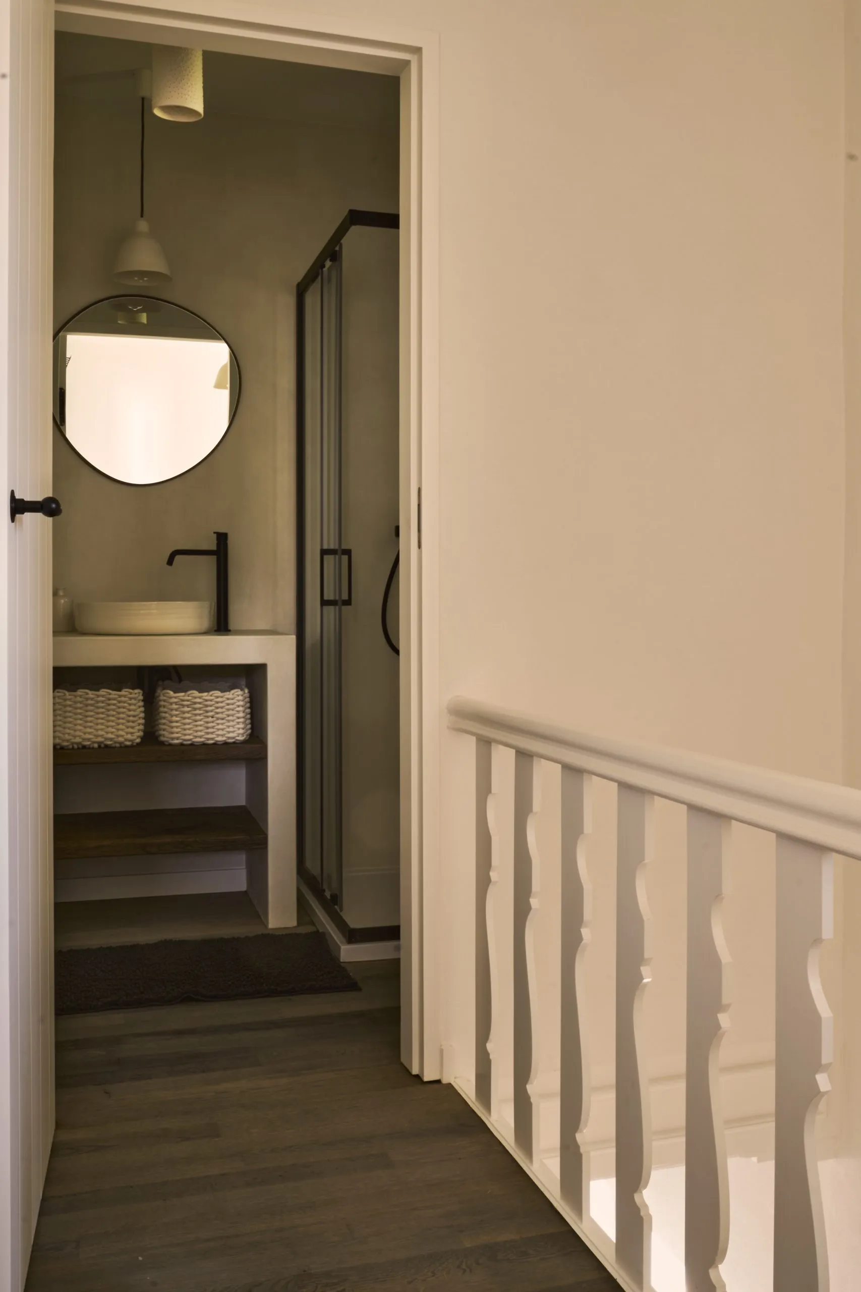 Twin bedroom with white walls and ceramic lamp