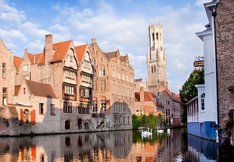 Bruges canal with historic guild houses reflected in the water
